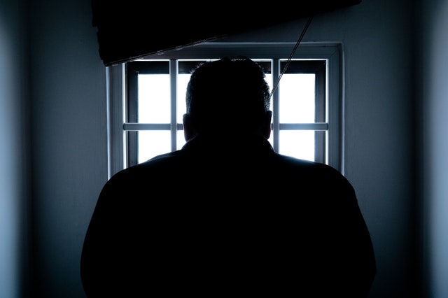 Person looking out of a prison window